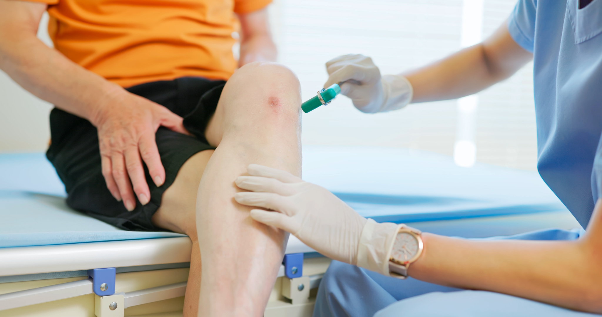 doctor examining patient knee